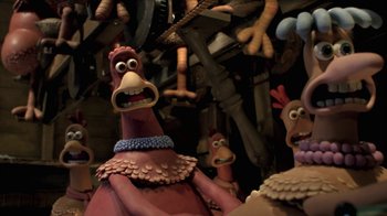 Movie still from “Chicken Run” (2000), directed by Peter Lord – A group of cartoon characters are standing in front of a wall; Close Up shot, High angle