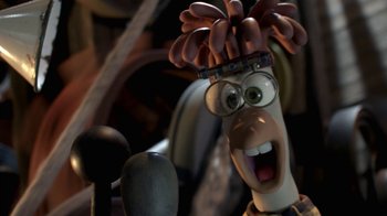 Movie still from “Chicken Run” (2000), directed by Peter Lord – A character's face with a bunch of sausages on his head; Close Up shot, High angle