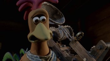 Movie still from “Chicken Run” (2000), directed by Peter Lord – A cartoon chicken with a pink head and a purple beak; Close Up shot, High angle