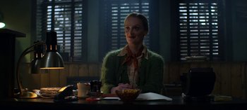 Movie still from “Chilling Adventures of Sabrina” (2018), created by Roberto Aguirre-Sacasa – A woman sitting at a table with a bowl of cereal; Medium shot, Over the shoulder angle