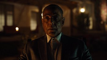 Movie still from “Better Call Saul” (2015), created by Vince Gilligan – An older man wearing a suit and tie in a dark room; Close Up shot, Low angle