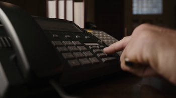 Movie still from “Better Call Saul” (2015), created by Vince Gilligan – A person using a computer keyboard on top of a desk; Extreme Close Up shot, High angle