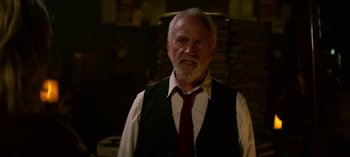 Movie still from “Chilling Adventures of Sabrina” (2018), created by Roberto Aguirre-Sacasa – An older man wearing a vest and a red tie; Medium shot, Over the shoulder angle