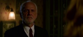 Movie still from “Chilling Adventures of Sabrina” (2018), created by Roberto Aguirre-Sacasa – An older man wearing a suit and tie; Close Up shot, Low angle