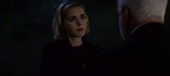 Movie still from “Chilling Adventures of Sabrina” (2018), created by Roberto Aguirre-Sacasa – A woman in a black jacket is looking at a man; Close Up shot, Over the shoulder angle