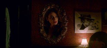 Movie still from “Chilling Adventures of Sabrina” (2018), created by Roberto Aguirre-Sacasa – A woman is looking into a mirror in a room; Close Up shot, Low angle