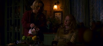 Movie still from “Chilling Adventures of Sabrina” (2018), created by Roberto Aguirre-Sacasa – Two women sitting at a table with a bowl of fruit; Medium shot, Over the shoulder angle