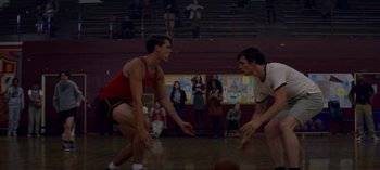 Movie still from “Chilling Adventures of Sabrina” (2018), created by Roberto Aguirre-Sacasa – Two young men are playing a game of basketball; Medium shot, Over the shoulder angle