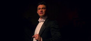 Movie still from “Chilling Adventures of Sabrina” (2018), created by Roberto Aguirre-Sacasa – A man in a suit and a bow tie; Close Up shot, Low angle