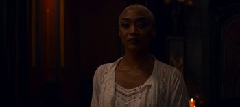 Movie still from “Chilling Adventures of Sabrina” (2018), created by Roberto Aguirre-Sacasa – A woman with a shaved head is posing for a picture; Close Up shot, Over the shoulder angle