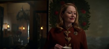 Movie still from “Chilling Adventures of Sabrina” (2018), created by Roberto Aguirre-Sacasa – A woman in a red coat holding a cup; Close Up shot, Over the shoulder angle