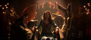 Movie still from “Chilling Adventures of Sabrina” (2018), created by Roberto Aguirre-Sacasa – A woman sitting on a throne surrounded by statues; Medium shot, Low angle