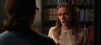 Movie still from “Chilling Adventures of Sabrina” (2018), created by Roberto Aguirre-Sacasa – A woman in a white shirt is talking to a man in glasses; Close Up shot, Over the shoulder angle