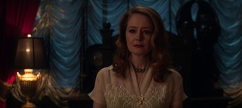 Movie still from “Chilling Adventures of Sabrina” (2018), created by Roberto Aguirre-Sacasa – A woman in a white shirt is looking at the camera; Close Up shot, Over the shoulder angle