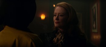 Movie still from “Chilling Adventures of Sabrina” (2018), created by Roberto Aguirre-Sacasa – A woman in a black jacket and a brown scarf; Close Up shot, Over the shoulder angle