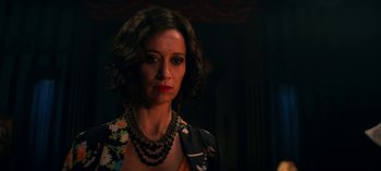 Movie still from “Chilling Adventures of Sabrina” (2018), created by Roberto Aguirre-Sacasa – A person with short hair wearing a necklace; Close Up shot, Over the shoulder angle