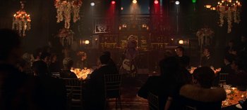 Movie still from “Chilling Adventures of Sabrina” (2018), created by Roberto Aguirre-Sacasa – A group of people sitting at tables in a room; Wide shot, Over the shoulder angle