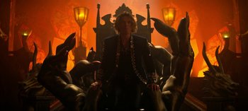 Movie still from “Chilling Adventures of Sabrina” (2018), created by Roberto Aguirre-Sacasa – A man sitting on a throne surrounded by statues; Wide shot, Low angle