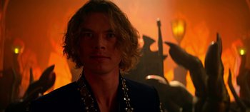 Movie still from “Chilling Adventures of Sabrina” (2018), created by Roberto Aguirre-Sacasa – A man with long blonde hair wearing a black jacket; Close Up shot, Over the shoulder angle