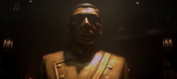 A statue of a man in a uniform is lit up