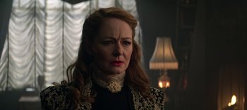 Movie still from “Chilling Adventures of Sabrina” (2018), created by Roberto Aguirre-Sacasa – An older woman with red hair wearing a black and white dress; Close Up shot, Over the shoulder angle