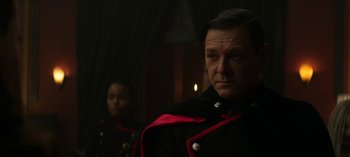 Movie still from “Chilling Adventures of Sabrina” (2018), created by Roberto Aguirre-Sacasa – A man in a military uniform stands next to a woman in a uniform; Close Up shot, Over the shoulder angle