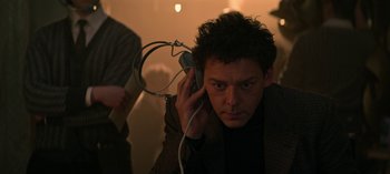 Movie still from “Chilling Adventures of Sabrina” (2018), created by Roberto Aguirre-Sacasa – A man with headphones is listening to music; Close Up shot, Low angle