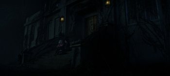 Movie still from “Chilling Adventures of Sabrina” (2018), created by Roberto Aguirre-Sacasa – Two people sitting on a bench in front of a building; Wide shot, High angle
