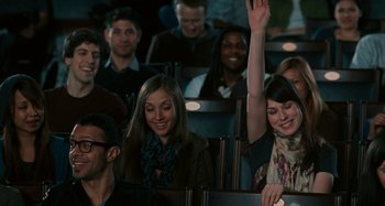 Movie still from “Chloe” (2009), directed by Atom Egoyan – A group of people sitting in a row of chairs; Medium shot, Over the shoulder angle