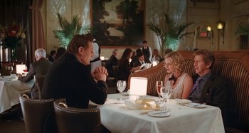 Movie still from “Chloe” (2009), directed by Atom Egoyan – A man and a woman sitting at a table with wine glasses; Medium shot, Over the shoulder angle
