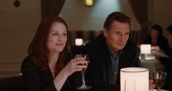Movie still from “Chloe” (2009), directed by Atom Egoyan – A man and a woman sitting next to each other at a table; Close Up shot, Over the shoulder angle