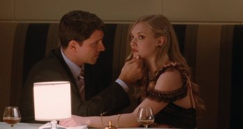 Movie still from “Chloe” (2009), directed by Atom Egoyan – A man and a woman sitting at a dinner table; Close Up shot, Over the shoulder angle