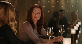 Movie still from “Chloe” (2009), directed by Atom Egoyan – A woman sitting in front of two glasses of wine; Close Up shot, Over the shoulder angle