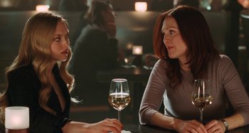 Movie still from “Chloe” (2009), directed by Atom Egoyan – Two women sitting at a table with a glass of white wine; Close Up shot, Over the shoulder angle