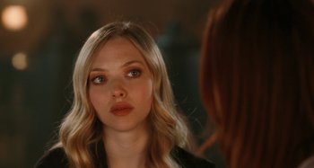 Movie still from “Chloe” (2009), directed by Atom Egoyan – A beautiful young woman looking at the camera in front of a mirror; Close Up shot, Over the shoulder angle