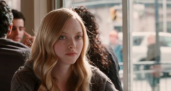 Movie still from “Chloe” (2009), directed by Atom Egoyan – A woman with long blonde hair sitting in front of a window; Close Up shot, Over the shoulder angle