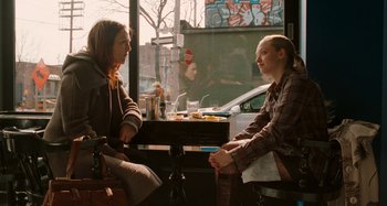 Movie still from “Chloe” (2009), directed by Atom Egoyan – Two women sitting at a table in front of each other; Medium shot, Over the shoulder angle
