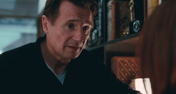 Movie still from “Chloe” (2009), directed by Atom Egoyan – Liam neeson sitting at a table; Close Up shot, Over the shoulder angle