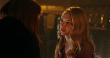 Movie still from “Chloe” (2009), directed by Atom Egoyan – A woman with long blonde hair standing next to another woman; Close Up shot, Over the shoulder angle
