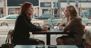 Movie still from “Chloe” (2009), directed by Atom Egoyan – Two women sitting at a table in front of each other; Medium shot, Over the shoulder angle