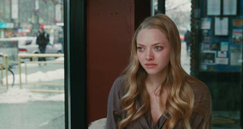 Movie still from “Chloe” (2009), directed by Atom Egoyan – A woman with long blonde hair sitting in front of a window; Close Up shot, Over the shoulder angle
