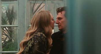 Movie still from “Chloe” (2009), directed by Atom Egoyan – A man and a woman kissing in front of a window; Close Up shot, Over the shoulder angle