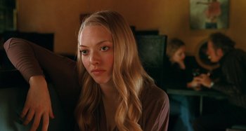 Movie still from “Chloe” (2009), directed by Atom Egoyan – A woman with long blonde hair sitting in front of a computer; Close Up shot, Over the shoulder angle