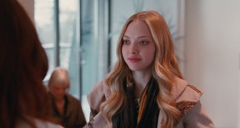 Movie still from “Chloe” (2009), directed by Atom Egoyan – A beautiful young woman with long blonde hair and blue eyes; Close Up shot, Over the shoulder angle