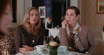 Movie still from “Chloe” (2009), directed by Atom Egoyan – Two women sitting at a table with tea cups; Medium shot, Over the shoulder angle