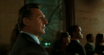 Movie still from “Chloe” (2009), directed by Atom Egoyan – A person wearing a suit and tie; Close Up shot, Low angle