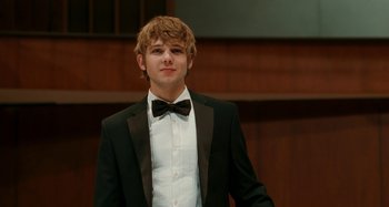 Movie still from “Chloe” (2009), directed by Atom Egoyan – A young man in a suit and a bow tie; Close Up shot, Low angle