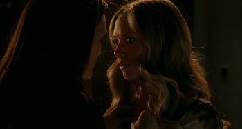 Movie still from “Chloe” (2009), directed by Atom Egoyan – A beautiful young blonde woman looking at the camera; Close Up shot, Over the shoulder angle