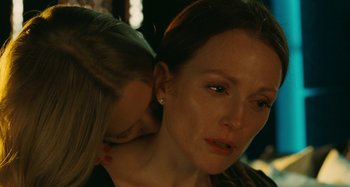 Movie still from “Chloe” (2009), directed by Atom Egoyan – A woman with her head resting on the shoulder of another woman; Close Up shot, Over the shoulder angle