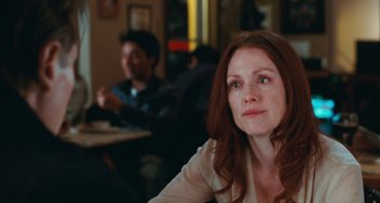Movie still from “Chloe” (2009), directed by Atom Egoyan – A person sitting at a table; Close Up shot, Over the shoulder angle